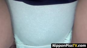 Naughty Japanese sweetie peeing through red panties outdoors