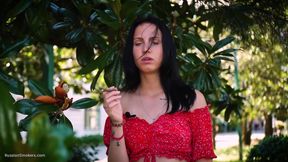 Sultry Brunette in Red Dress Smoking Rolled Cigarette