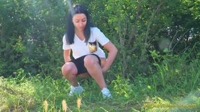 Trying hard to empty her bladder outside