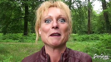 Mature blonde woman, Mendy is having casual sex in the nature, with a group of horny guys