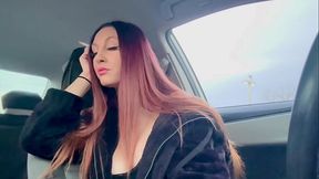 Italian MILF with big tits and long hair smokes in the car