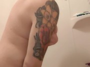 Tatted MILF plays with dildo in the shower