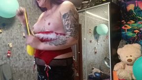 Girl poping big yellow balloon eith pump