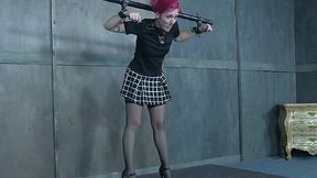 Pale skin white chick with dyed pink hair shackled to the metal pole