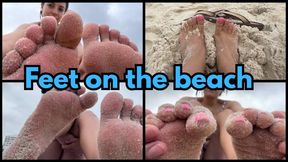 Foot worship on the beach and soles of feet with sand