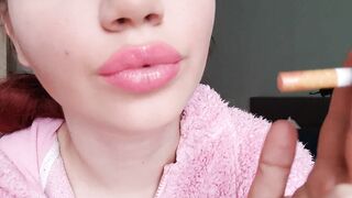 Glossy pink lips close up smoking