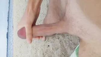 Solo guy strokes solo male jerks big cock on public beach