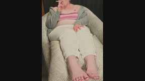 On chaise showing hands and feet smoking as always