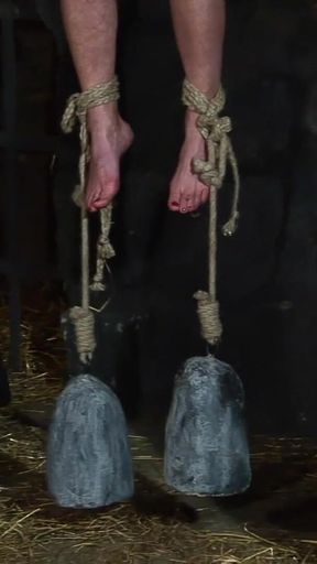 Blonde Girl Has Weights Attached to Her Feet and Is Hoisted up for Whipping