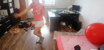 Amateur woman has fun trying on clothes and cutting them.