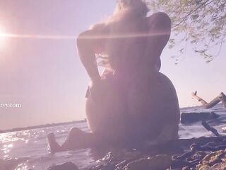 Bikini booty teasing in the water at a public beach!