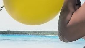 Beach sexy girl and an orange punchball pop