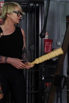 Slave Mila's Feet Dangle and Quiver as Mistress Baton Breaks in Heavy Wooden Paddle Over Her Jeans and Bare