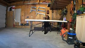 Garage whipping session with a collared slave under a folding table and thigh-high boots
