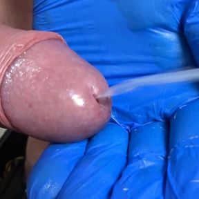 This horny guy jerks his cock with a latex glove until he unloads wonderfully