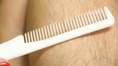 Unshaved woman combs its luscious body hair and massages its bushy cunt.