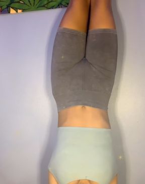 Woman doing handstand on wall