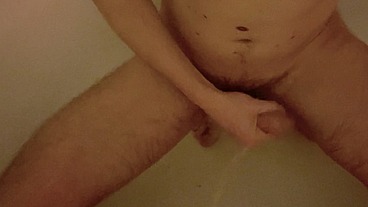 Naked amateur boy used as a urinal by his flatmate (he pees on his back, ass then body and hard cock)