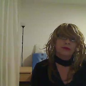 horny MILF tranny in front of the camera simulates a Blowjob while playing with a vibrator