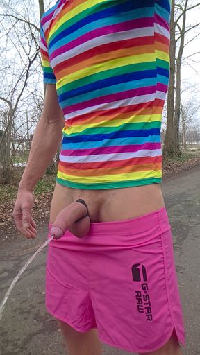 Skinny twink shows his thick cock outdoors and can be watched pissing. Hard cock pisses on the street.