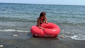 Red Swim Ring Deflation in the Water – Beach Fun