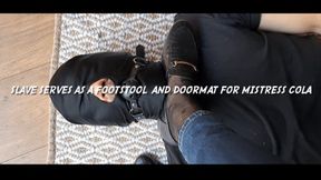 Slave serves as a footstool and doormat for Mistress Cola