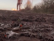 Naked barefoot muddy field