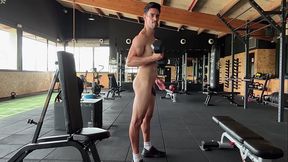 Fitness guy training fully naked on public gym