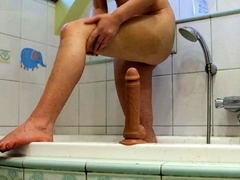 Redhead babe cums with her favorite toy after a shower.