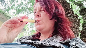Sexy chubby readhead smoke in a garden