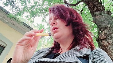 Sexy chubby readhead smoke in a garden