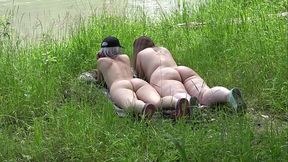 Two curvy Russian ladies enjoy their nude time in a river clearing while a