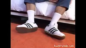 Cute stud gently playing with his feet and licking his toes