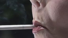 Profile view up close holding a VS 120 in my mouth w blue glasses