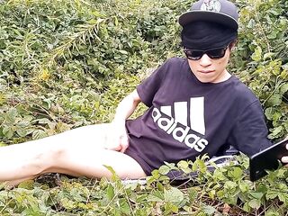 Cute French-Asian gay twink jerks off his shaved dong outside cums thick cum sticking to his fingers