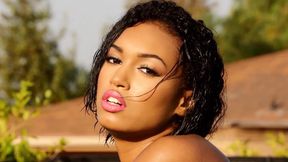 Seductive ebony Noelle gets naked at the pool