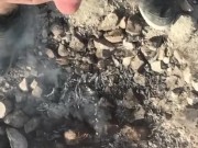 Slow motion piss too put out the campfire in the desert