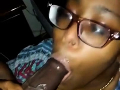 Nerdy ebony girl works her sexy lips on a thick black cock