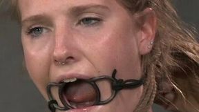 Blonde slave with a ring gag in her mouth is bounded and punished