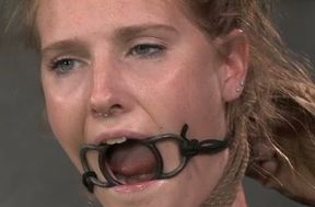 Blonde slave with a ring gag in her mouth is bounded and punished