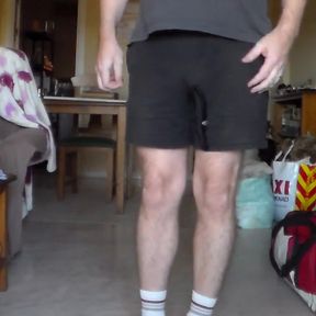 John is Peeing in his black shorts