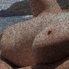 Julie Cunningham  lying nude on a beach