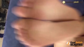 Barefoot redhead shows you her ass on the couch