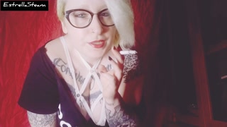 Blonde smokes a cigarette while staring at you