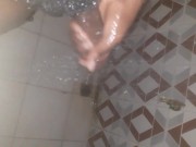 African teen mastrubating in the shower with his big cock