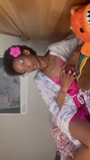 Woman in bathrobe sitting on bed