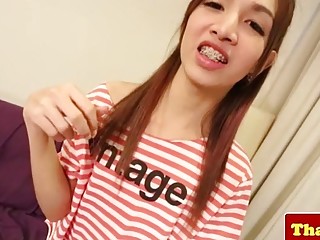 Thai skinny ladyboy with braces jerks herself