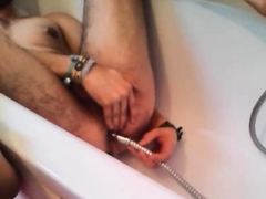 Bi-guy using shower head, squirting water, enema