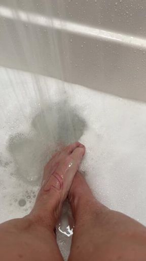 soaking tired, achy feet in bubbles
