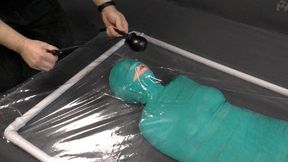 Mummification bandage vibrator and inflatable gag in a vacuum bed